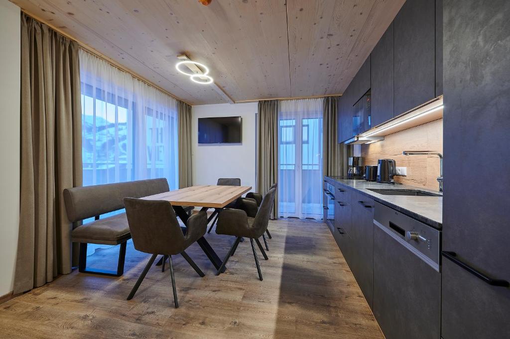 a kitchen and dining room with a table and chairs at Appartement Christina in Saalbach Hinterglemm