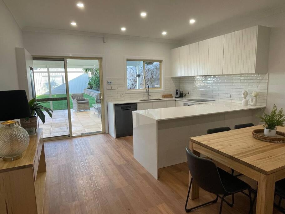 a large kitchen with a table and a dining room at House on Argent Street in Broken Hill
