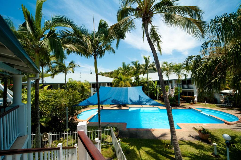 a hotel room with a pool and beach at Mango House Resort in Airlie Beach