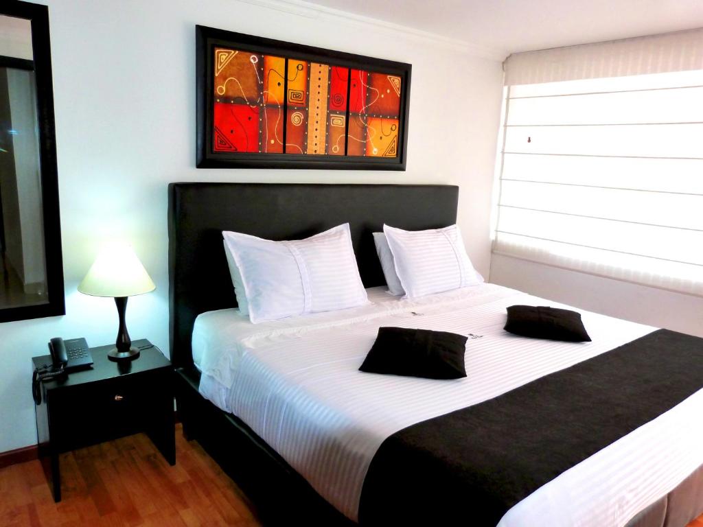 a bedroom with a large bed and a window at Hotel Radel Bogotá in Bogotá