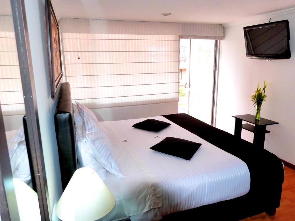 Postel nebo postele na pokoji v ubytování Hotel Radel Bogotá