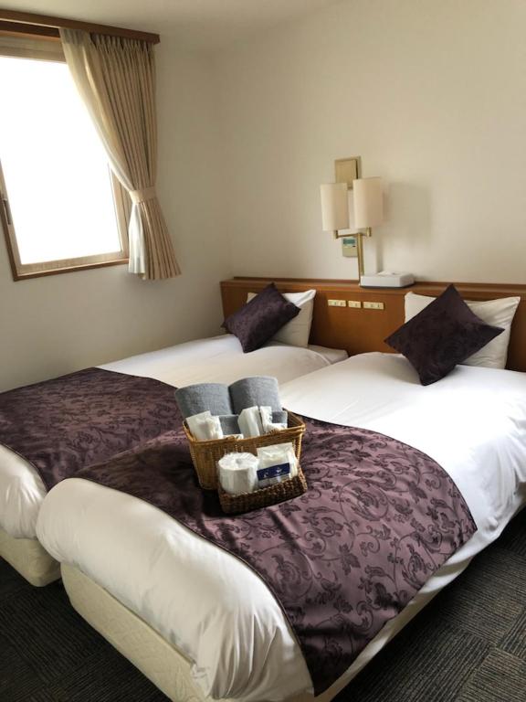 Postel nebo postele na pokoji v ubytování Hotel Plaisir Tachikawa