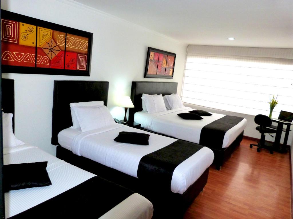 Postel nebo postele na pokoji v ubytování Hotel Radel Bogotá