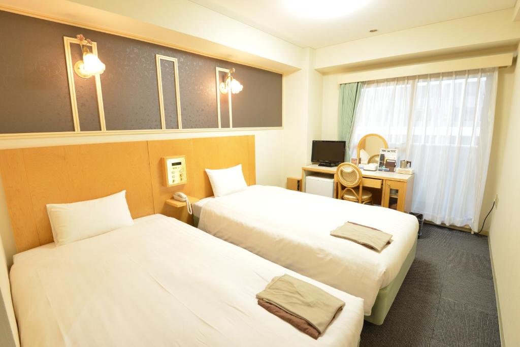 Postel nebo postele na pokoji v ubytování Hotel Marutani