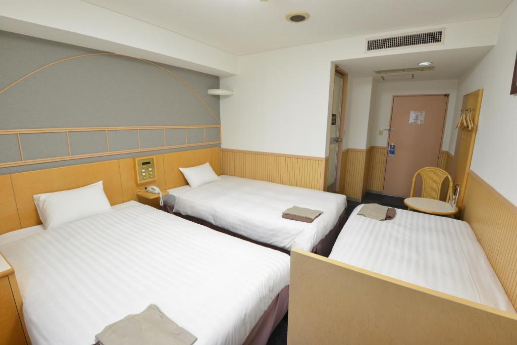 Postel nebo postele na pokoji v ubytování Hotel Marutani