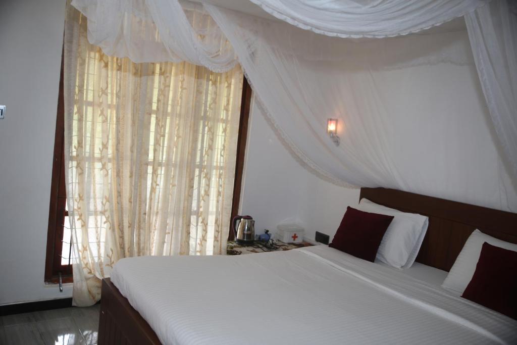 Postel nebo postele na pokoji v ubytování Cinnamon Homestay ella
