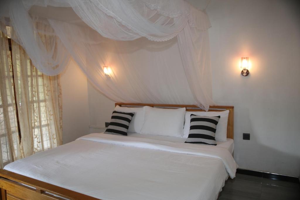 Postel nebo postele na pokoji v ubytování Cinnamon Homestay ella