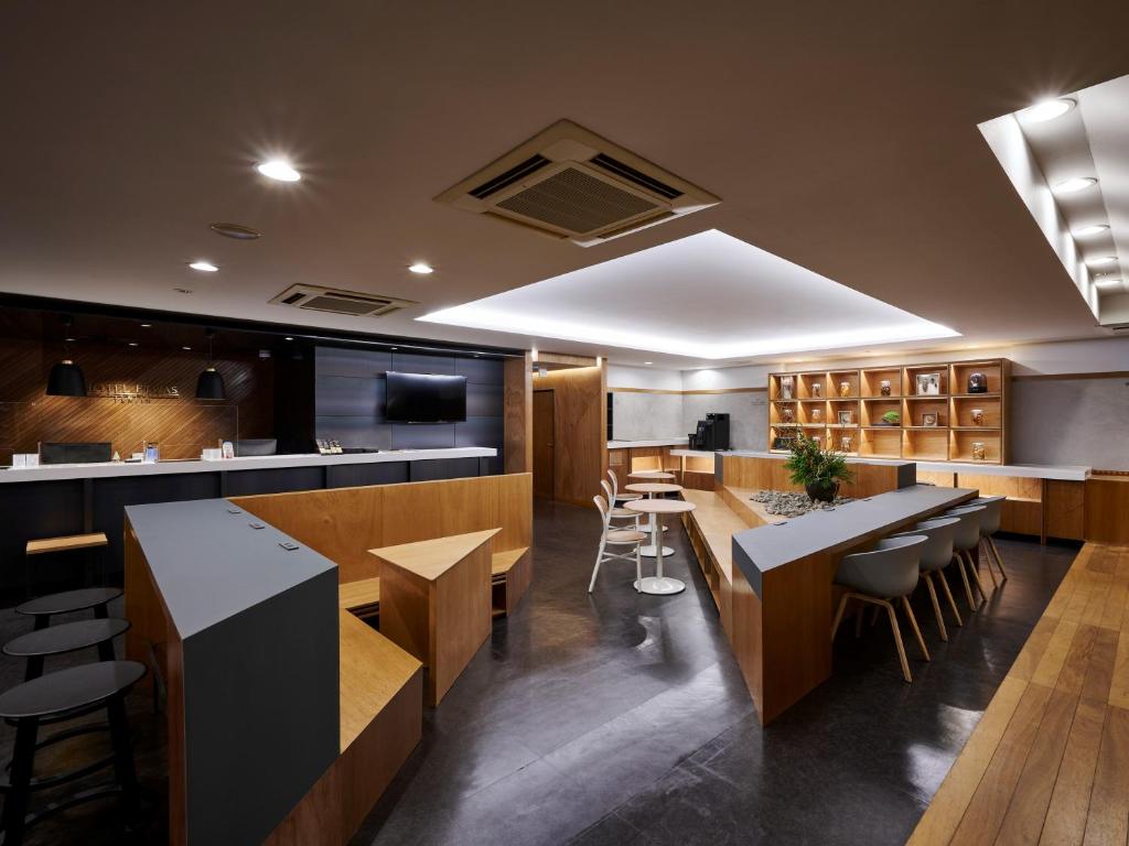 a restaurant with tables and chairs and a bar at Hotel Etwas Tenjin in Fukuoka