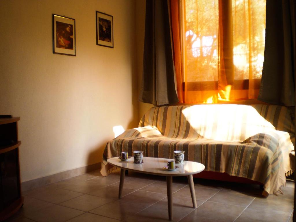 a bedroom with a bed and a coffee table at Louvis House in Akti Salonikiou