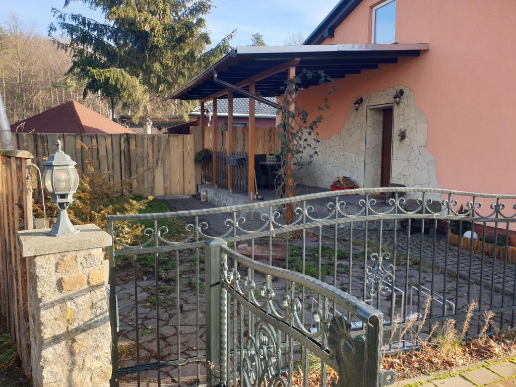 a wrought iron fence in front of a house at Ferienhaus Victoria in Schwarzheide