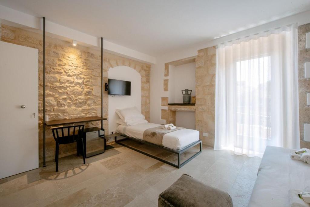 Postel nebo postele na pokoji v ubytování IBLA ROOMS