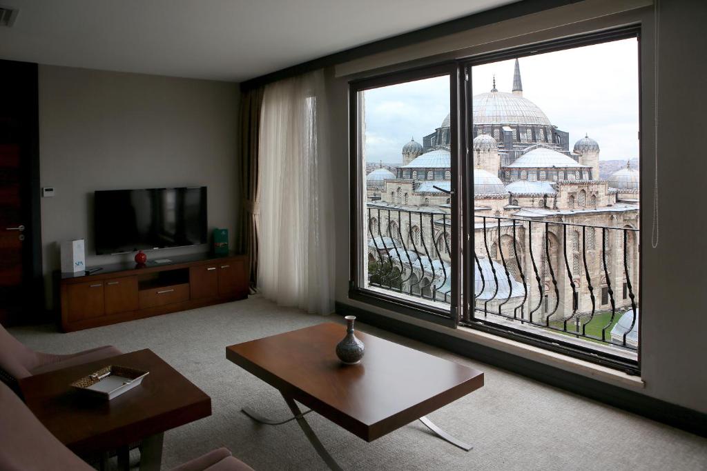 a living room with a view of the city from a window at Grand Hotel Gulsoy Old City in Istanbul
