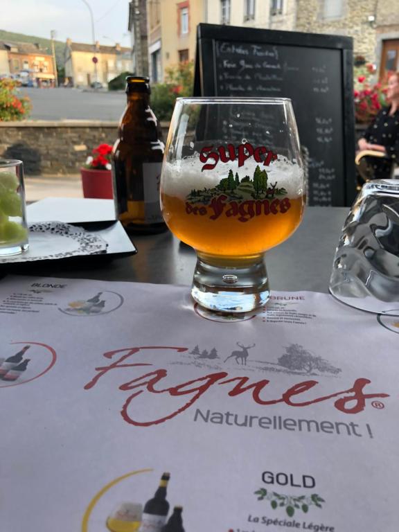 a glass of beer sitting on top of a table at Forest Lodge in Petit Mesnil