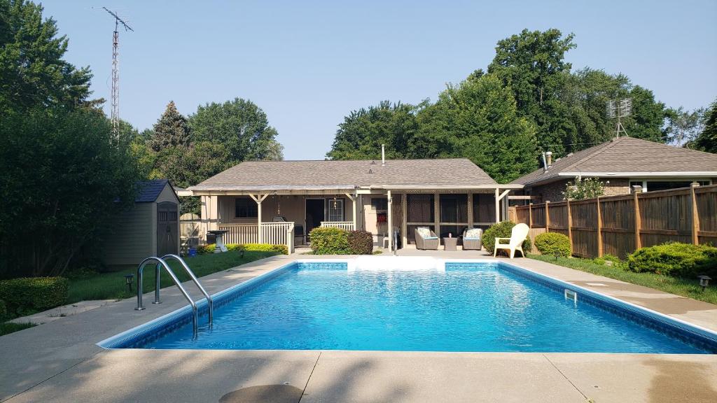 a swimming pool in front of a house at Luxurious Pool Cottage in Kingsville