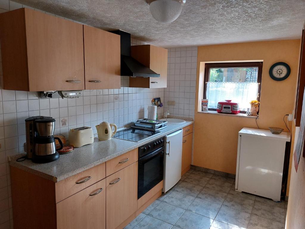 a kitchen with a sink and a stove top oven at Ferienzimmer Lichtlein in Rostock