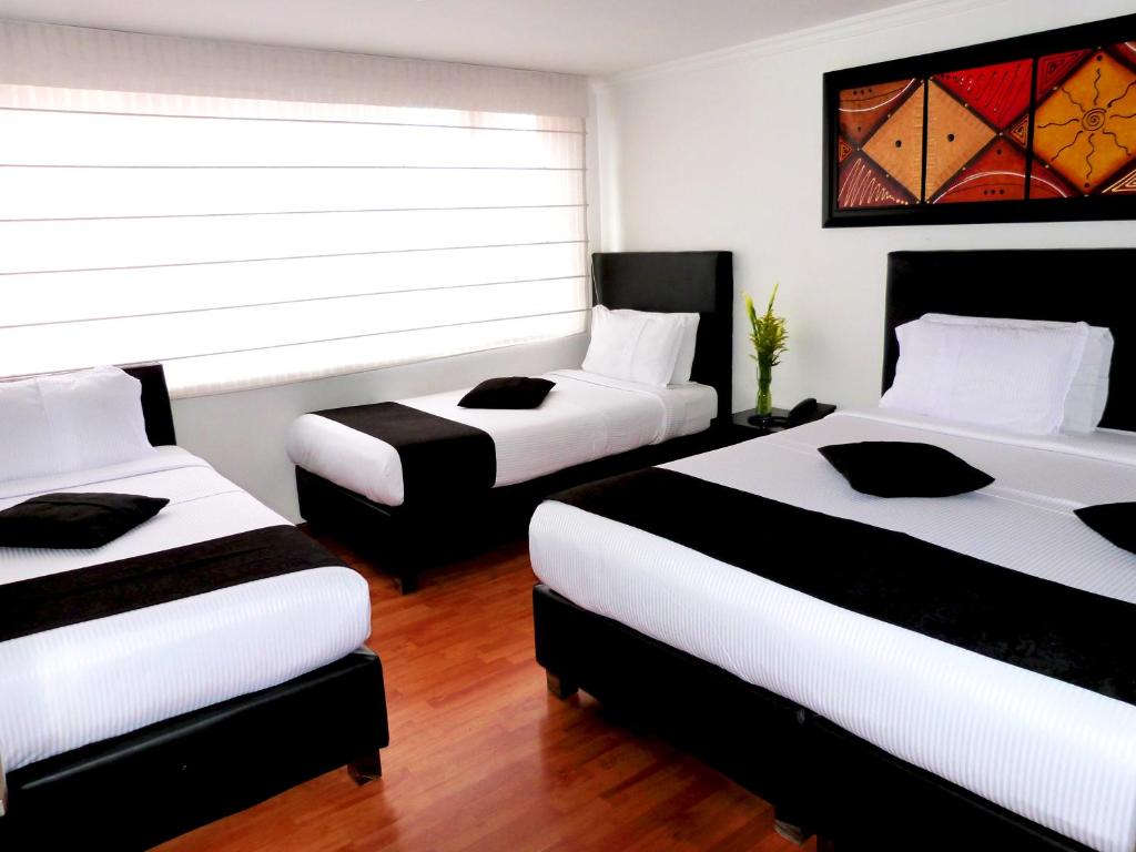 Postel nebo postele na pokoji v ubytování Hotel Radel Bogotá