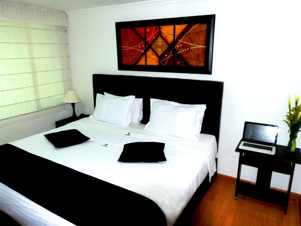 Postel nebo postele na pokoji v ubytování Hotel Radel Bogotá