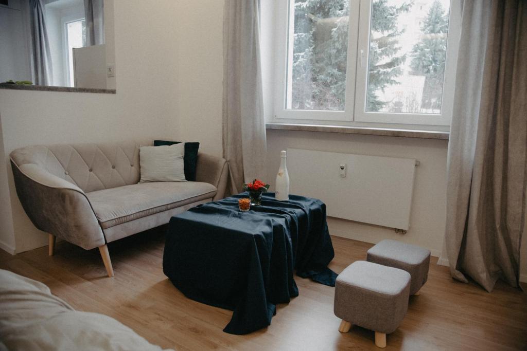a living room with a table and a chair at Apartman PENNY in Zvolen
