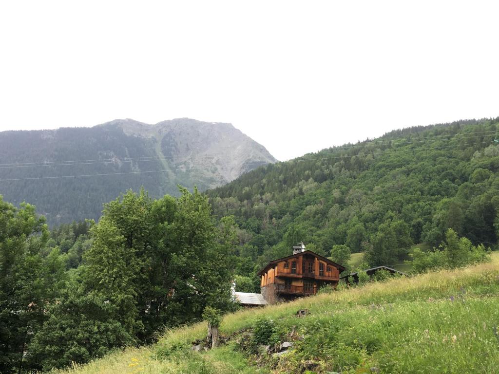 a house on a hill in the middle of a mountain at Chalet Altus in Sainte-Foy-Tarentaise