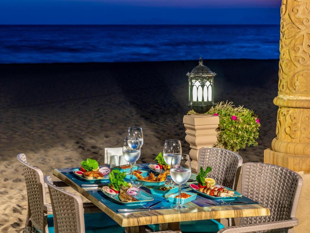 a table with food and wine glasses on the beach at Spice Hotel & Spa - Ultra All Inclusive in Belek