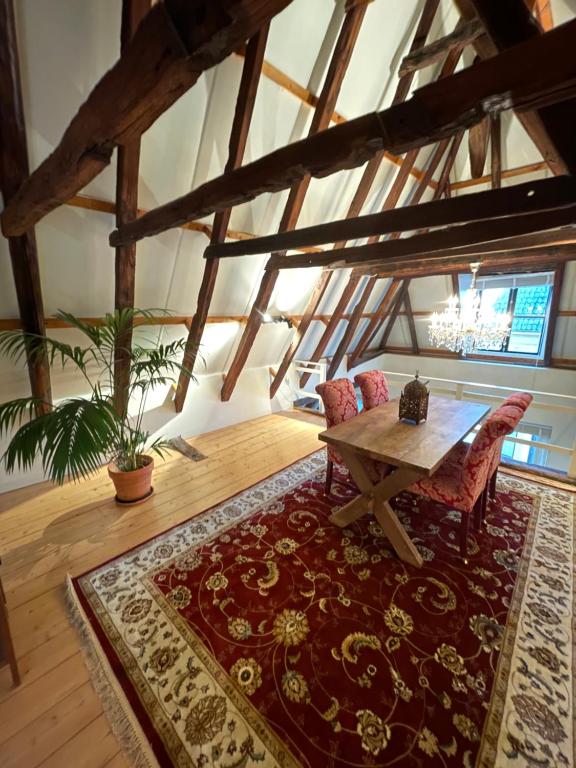 a living room with a wooden table and a rug at Julius Groningen in Groningen