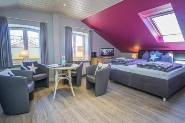 a bedroom with a bed and a table and chairs at Frau Holle in Westerland (Sylt)