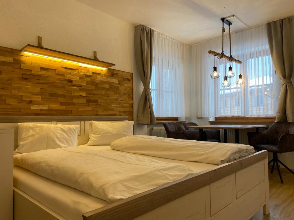 a bedroom with a large bed and a dining room at Haus Kristina in Riezlern