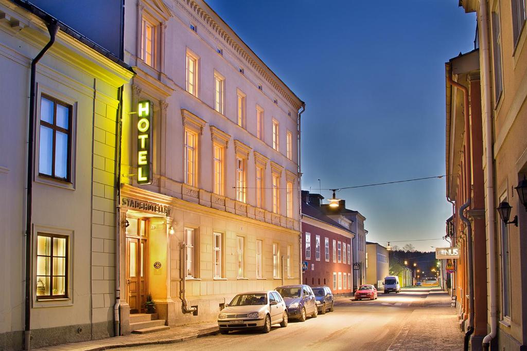 a street with cars parked on the side of a building at Arboga Stadshotell in Arboga