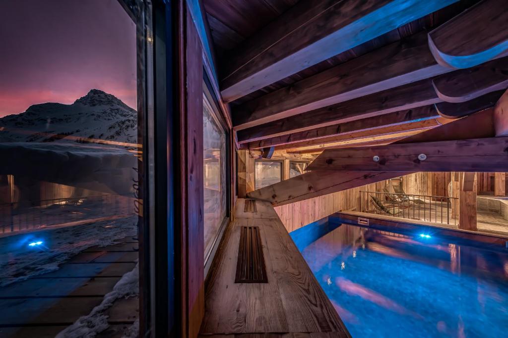 a house with a swimming pool at night at Hotel & Spa Le Val d'Isère in Val-d'Isère