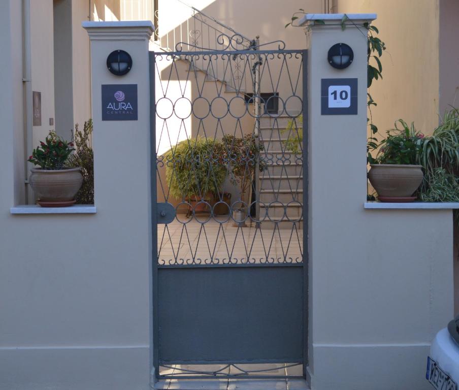 a door with a gate with potted plants at Aura central apartments in Argostoli