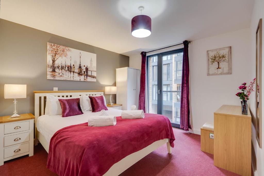 ein Schlafzimmer mit einem großen Bett und einem Fenster in der Unterkunft Arcadian City Centre Apartments with Balcony in Birmingham
