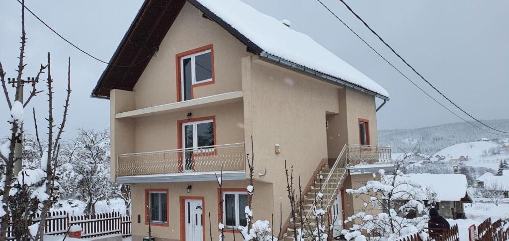 a house with snow on the side of it at Apartman Vera in Kremna