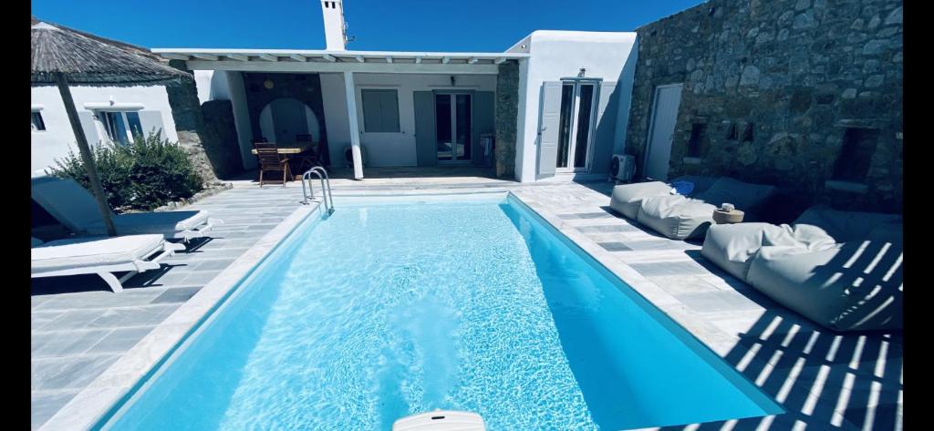 a swimming pool in the middle of a yard at Villa & Suite Elia Mykonos in Mikonos
