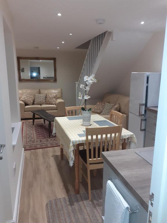 a kitchen and living room with a table and a couch at Station Retreat 6B Comberton Terrace in Kidderminster