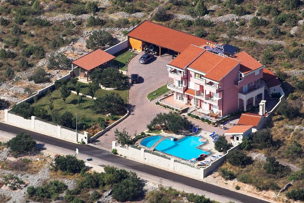 an aerial view of a house with a swimming pool at Apartments Marinić in Primošten