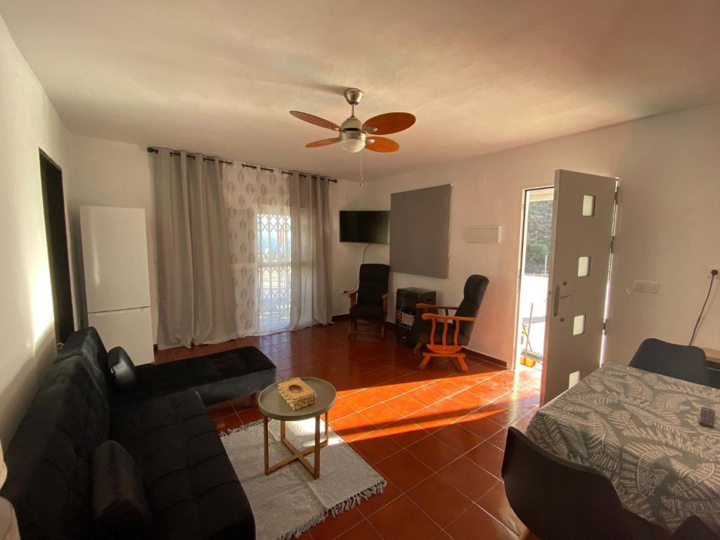 a living room with a couch and a table at Casa al sol in Adra