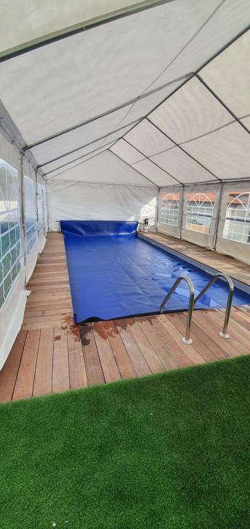 a swimming pool under a tent with blue water at kinneret love sounds in Migdal