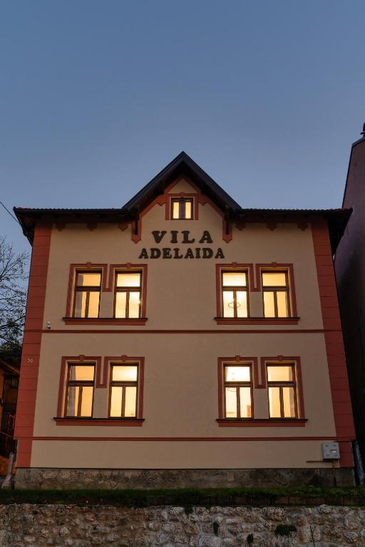 a building with a sign on the side of it at Villa Adelaida in Sarajevo