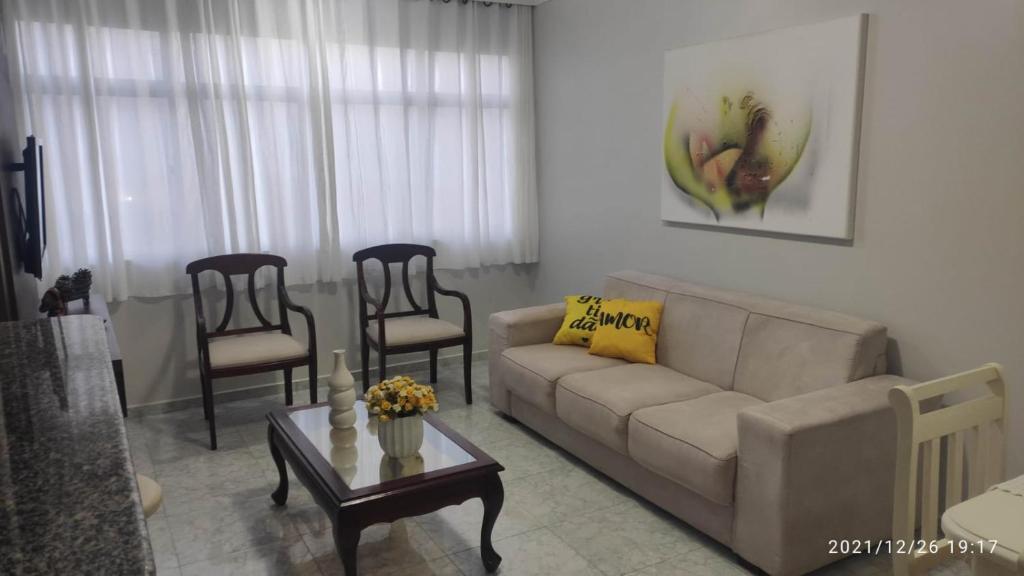 a living room with a couch and a table and chairs at Apartamento Beira mar in Arroio do Silva