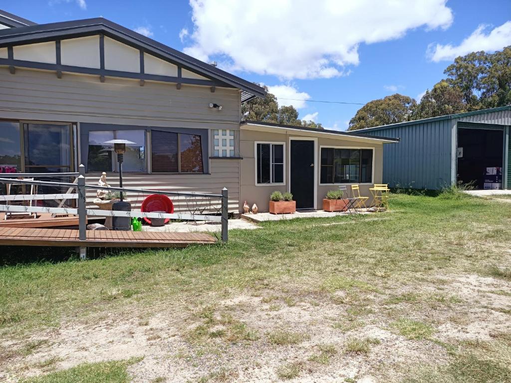 a home with a deck and a house at Happy Pig Farm in Stanthorpe