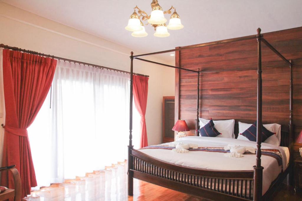 
a bedroom with a large bed and a large window at Rustic River Boutique in Chiang Mai
