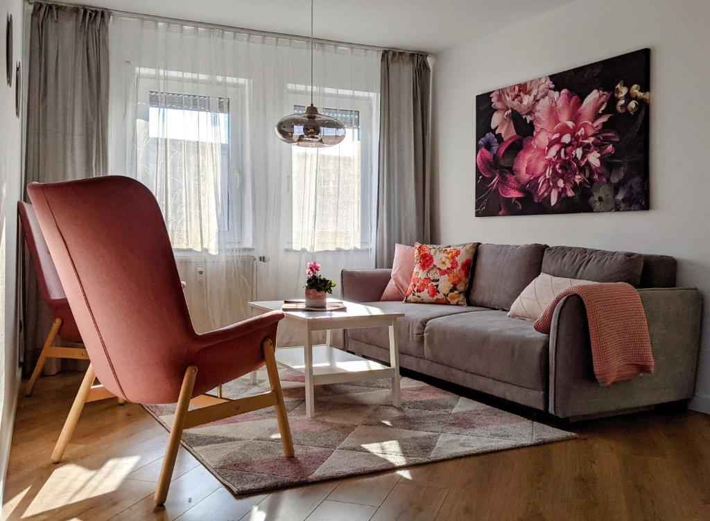 a living room with a couch and a table at Cozy Apartment with Parking Garage near Outlet in Metzingen