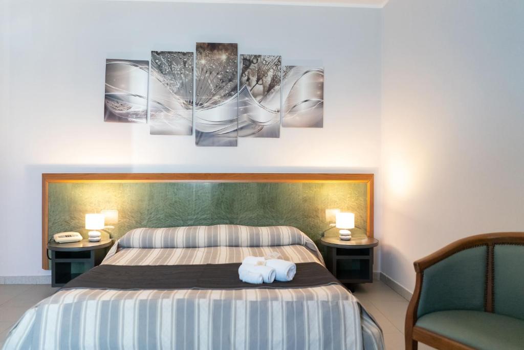 Postel nebo postele na pokoji v ubytování Hotel Melissa