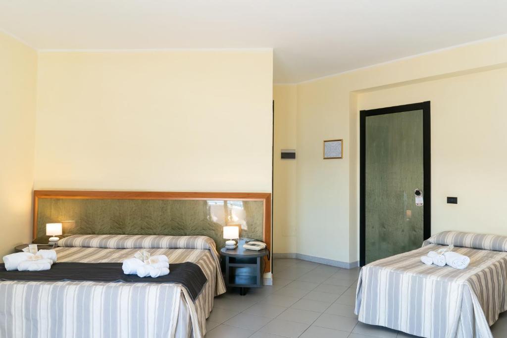 Postel nebo postele na pokoji v ubytování Hotel Melissa