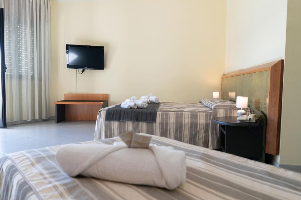 Postel nebo postele na pokoji v ubytování Hotel Melissa