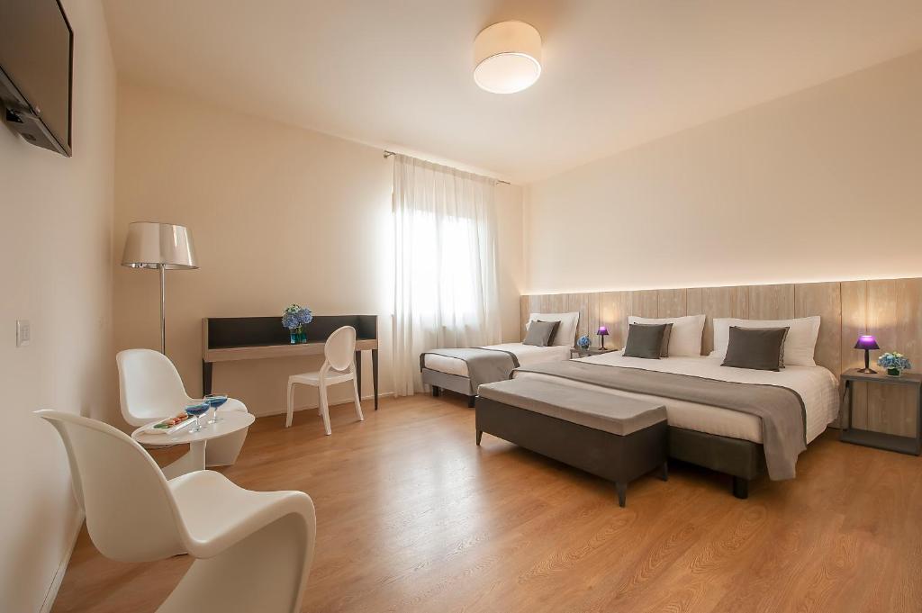 Postel nebo postele na pokoji v ubytování Hotel La Corte