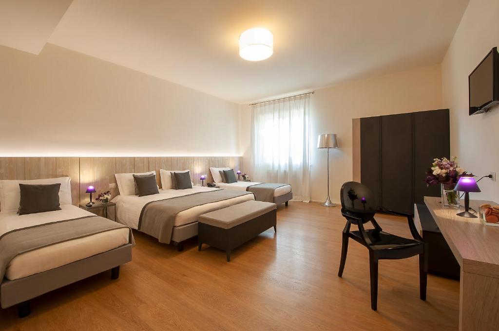 Postel nebo postele na pokoji v ubytování Hotel La Corte