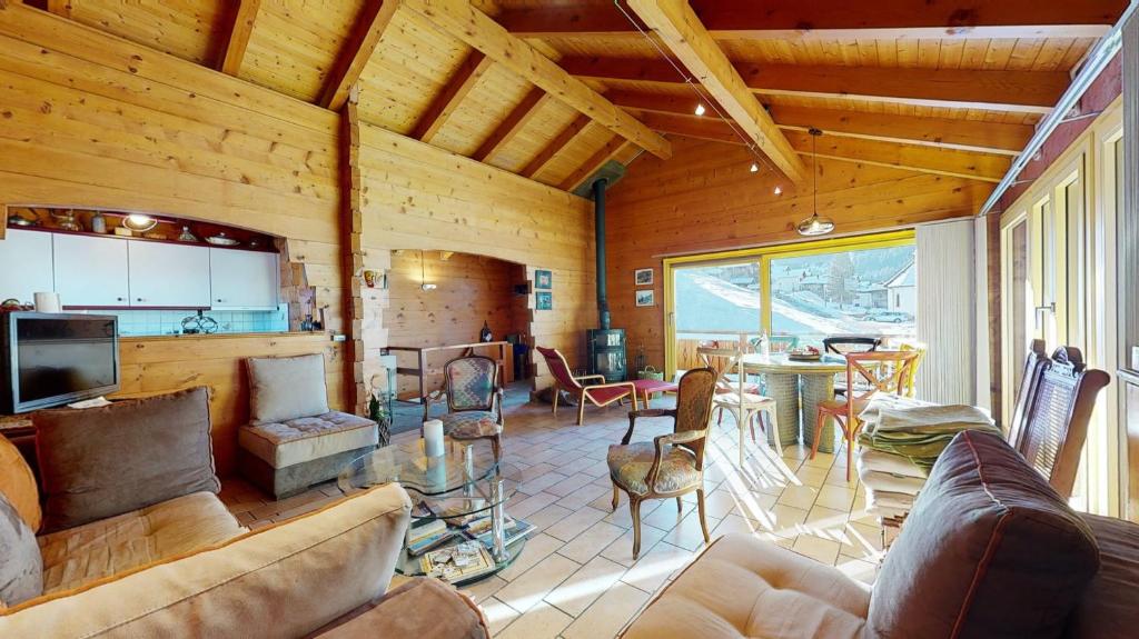 a living room with a couch and a table with chairs at Chalet in the heart of the Val d'Anniviers resort in Saint-Jean
