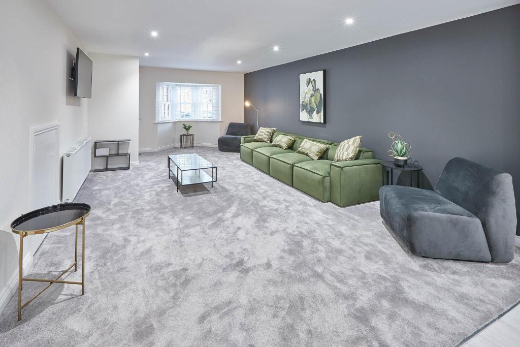 a living room with a green couch and chairs at Host & Stay - Littlebeck House in Sleights