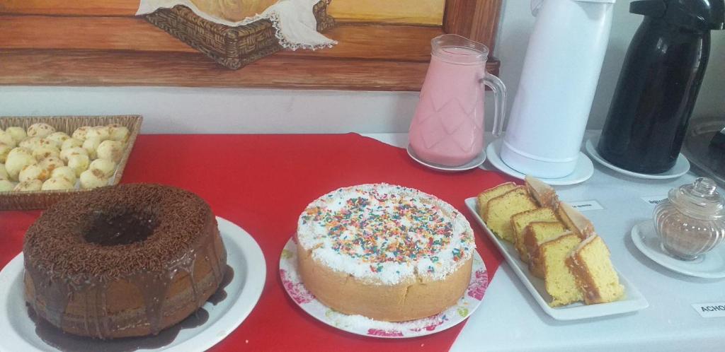 a table with different types of cakes and bread at Hotel Guarini in Monte Sião